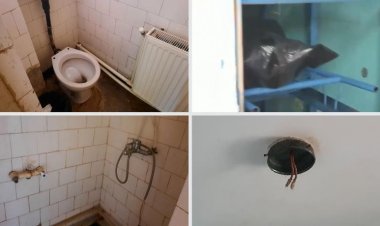 Muncitori fără mască obligaţi să dărâme un zid lângă mortul de COVID